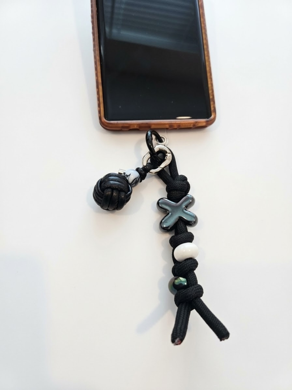Black Phone Charm Strap with Decorative Beads and Cross Accent